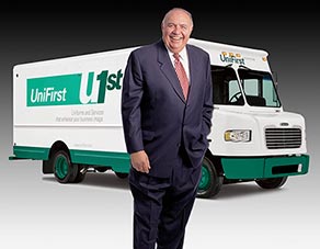 UniFirst CEO Ron Croatti stands in front of uniform delivery van