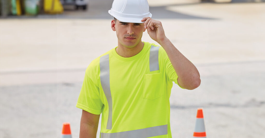 Construction worker in hard hat and high visibility t-shirt working at job site