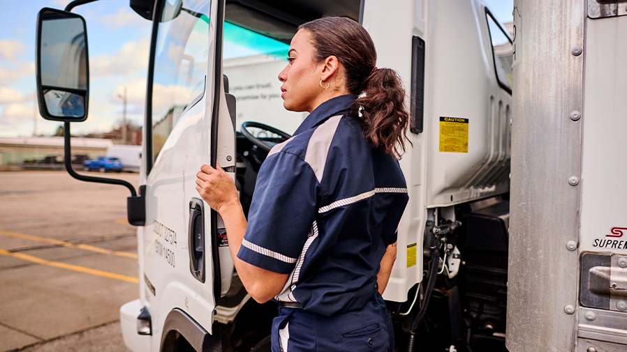 Woman wearing UniFirst Spotlite MV getting into a truck