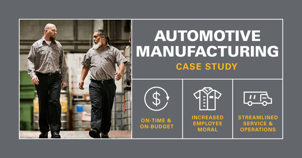Automotive manufacturing workers walking down ramp wearing UniFirst uniform rental service workwear.