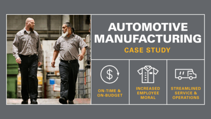 Automotive manufacturing workers walking down ramp wearing UniFirst uniform pants and shirts.