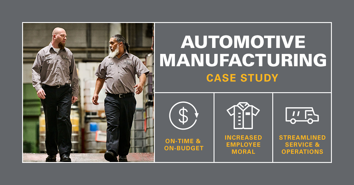 Automotive manufacturing workers walking down ramp wearing UniFirst uniform pants and shirts.
