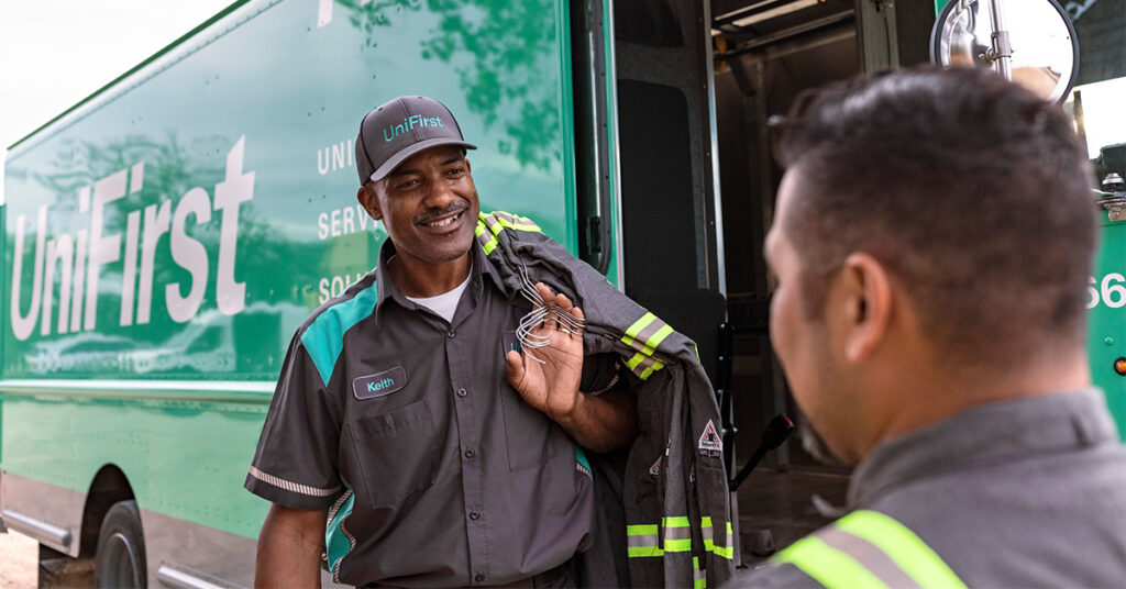 UniFirst Routes Service Representative talking with a oil and gas customer wearing industrial workwear