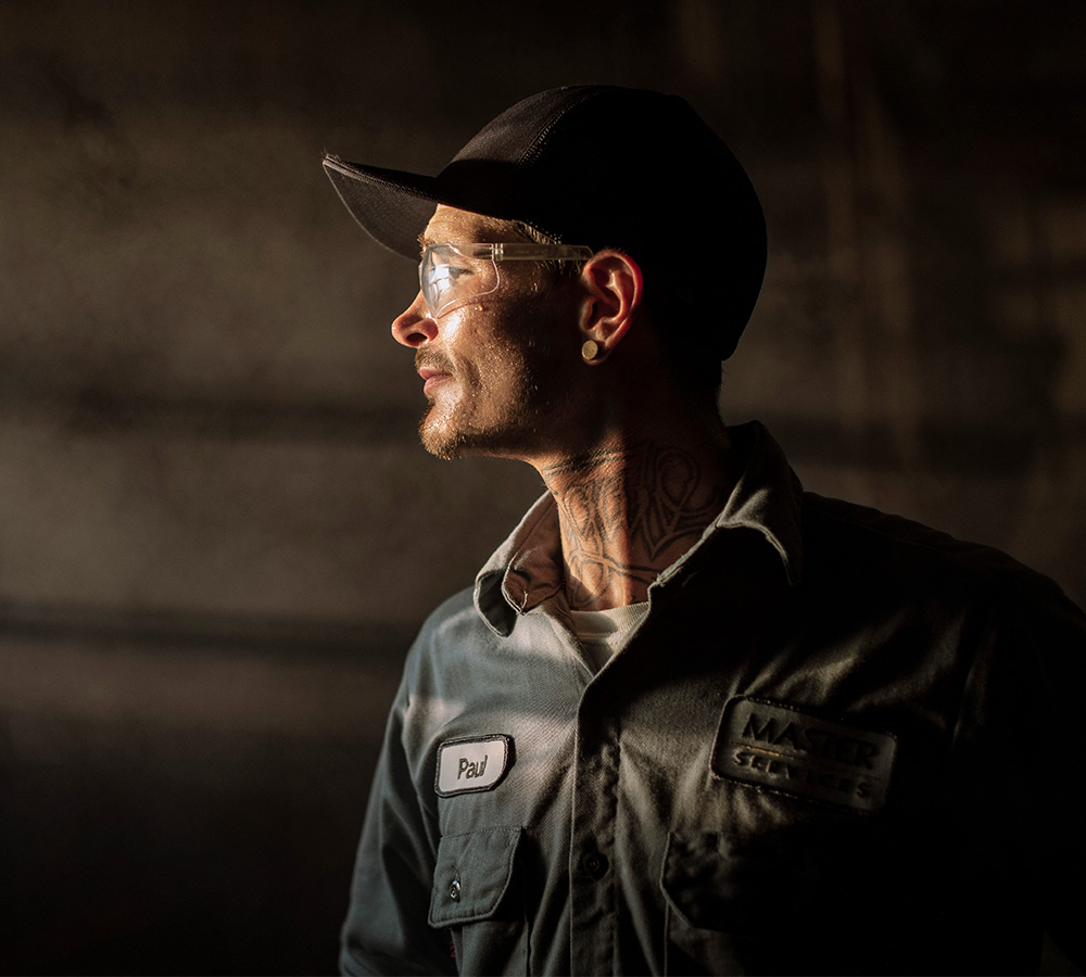 Industrial wholesale worker standing in UniFirst uniform pants and shirt