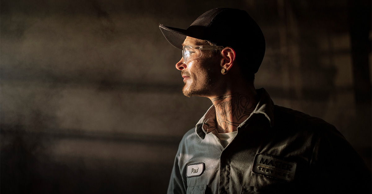 Industrial wholesale worker standing in UniFirst uniform pants and shirt