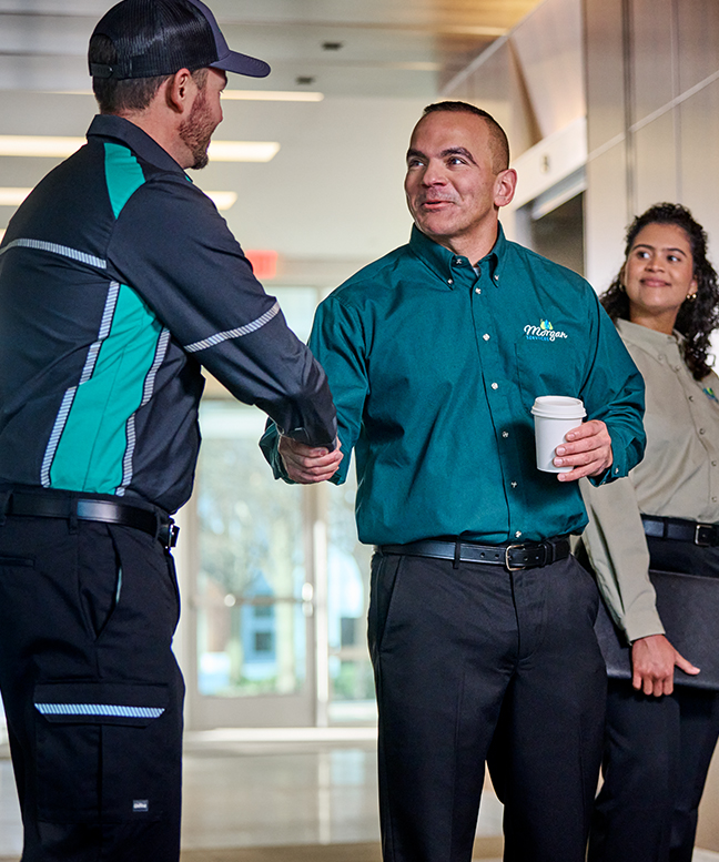 UniFirst RSR greeting customer wearing a button down shirt from uniform program