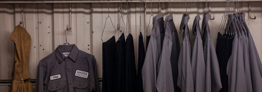 A rack of garments from a UniFirst uniform rental program one way to take control of indirect spend