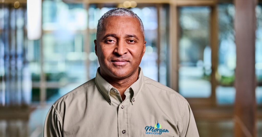 A uniform rental program customer standing proudly while wearing his workwear