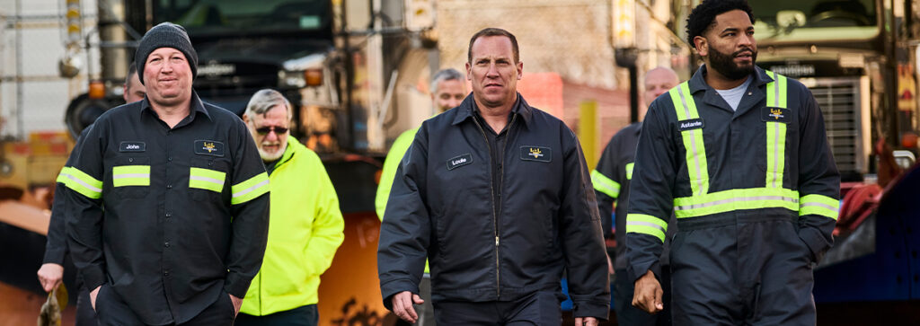 A group of workers walking together wearing uniforms that give them a professional look