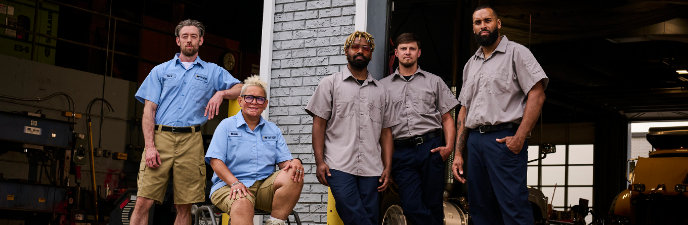 A group of workers stand together proudly wearing UniFirst's Always U collection of workwear
